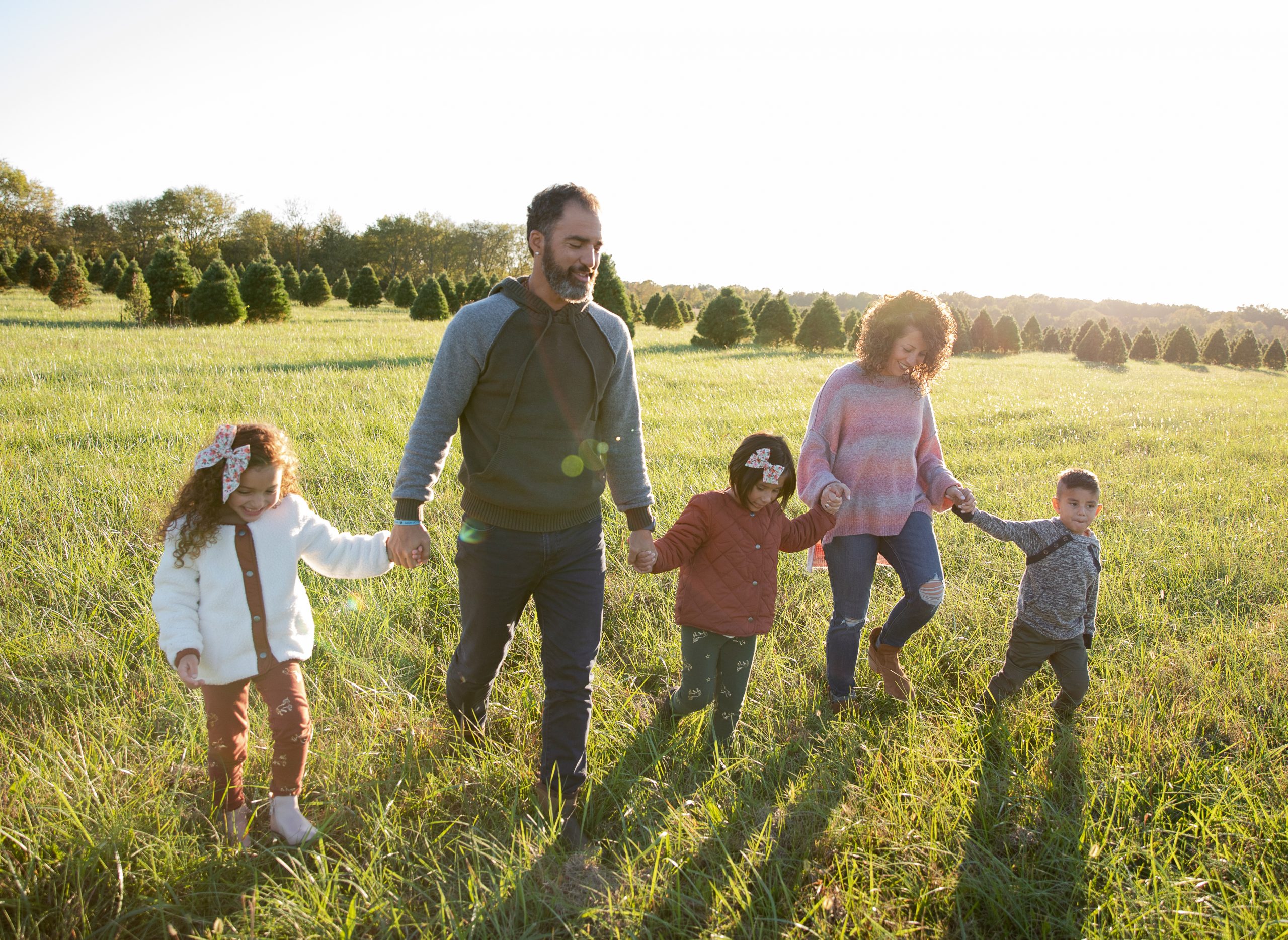 Show Hope Adoption Aid grant recipient family holding hands and walking in a field