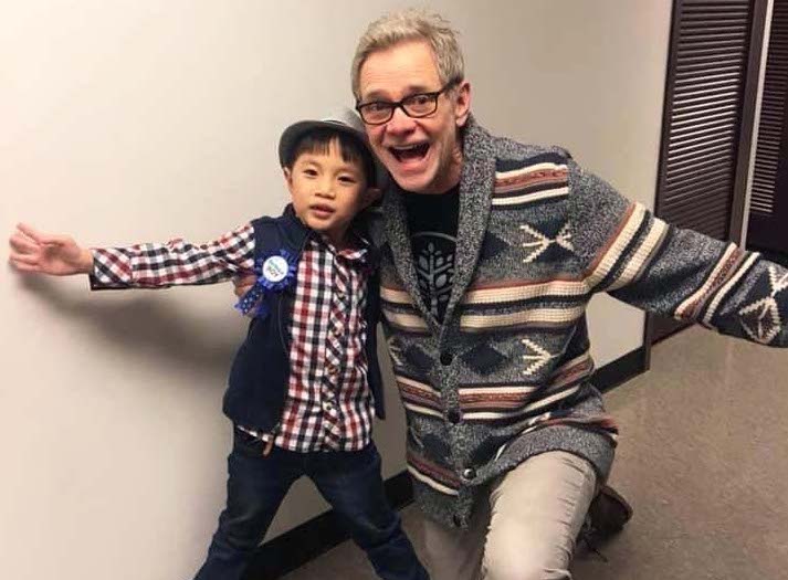 An image of Steven Curtis Chapman posing and smiling with Aiden Chabert