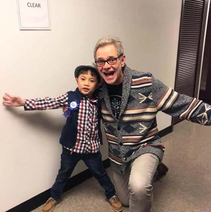 An image of Steven Curtis Chapman posing and smiling with Aiden Chabert