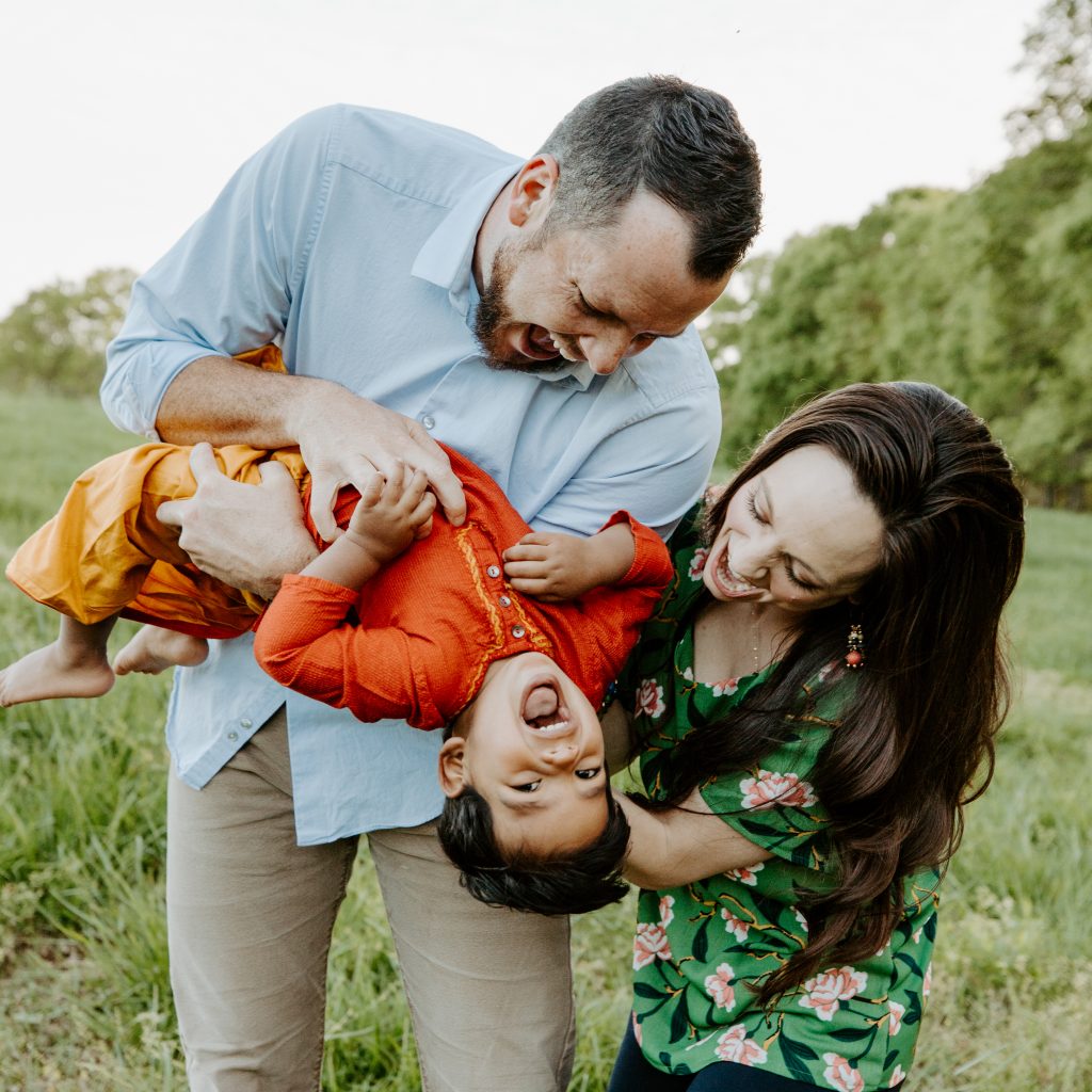 Show Hope Medical Care grant recipients, the Link family, holding and tickling their son