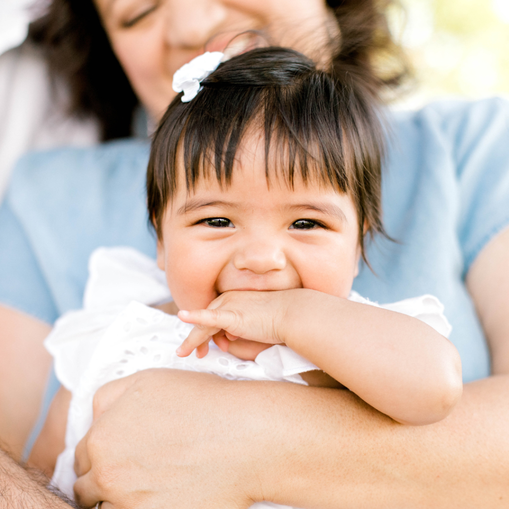 Daughter being held by her mother