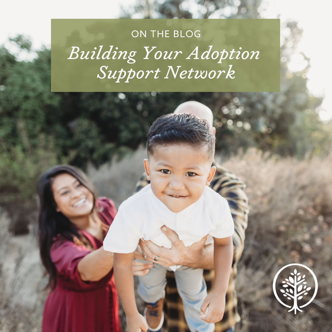 A mom and dad hold up their child who is looking at the camera, the family is a Show Hope Adoption Aid grant recipient family.