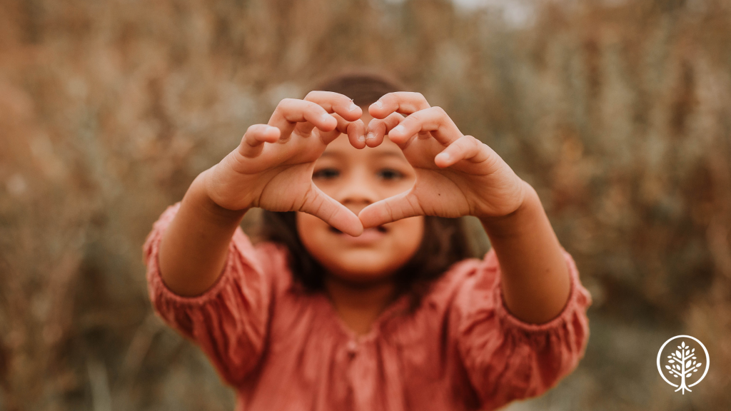 Girl making a heart shape with her hands