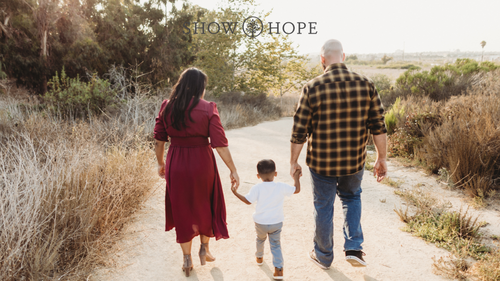 Show Hope Adoption Aid grant recipient family holding hands and walking outside