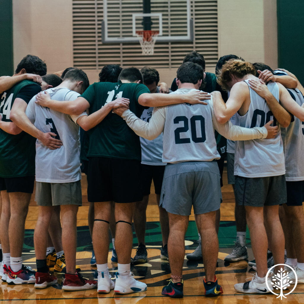 Phi Kappa Chi basketball team huddled together
