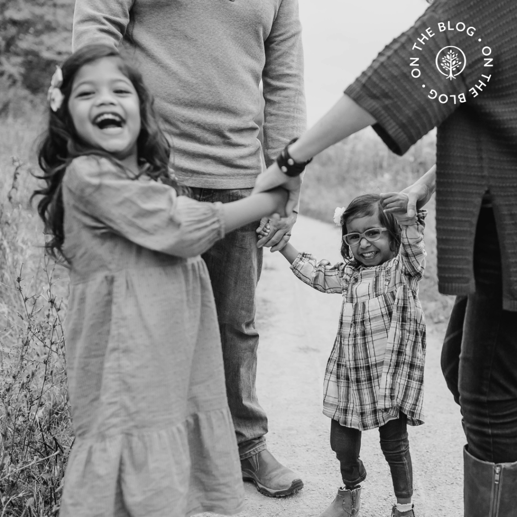 A Show Hope family holding hands in a circle and smiling