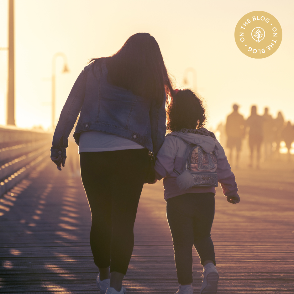 Mom and daughter holding hands and walking