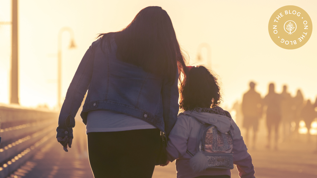 Mom and daughter holding hands and walking