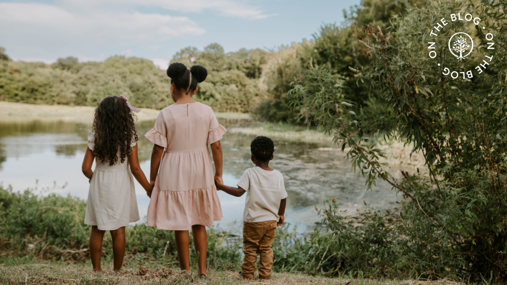 Show Hope Adoption Aid grant family's children holding hands and looking out over a pond