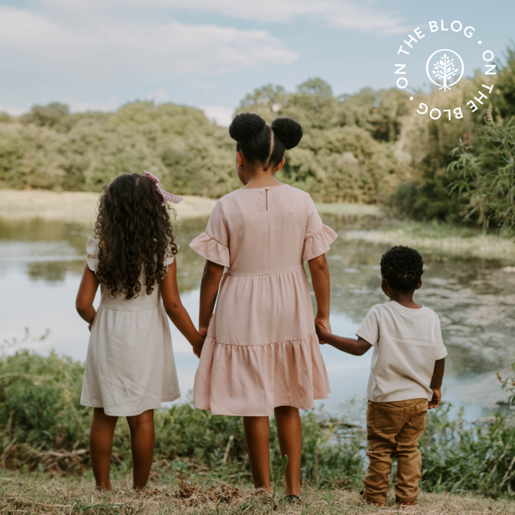 Show Hope Adoption Aid grant family's children holding hands and looking out over a pond