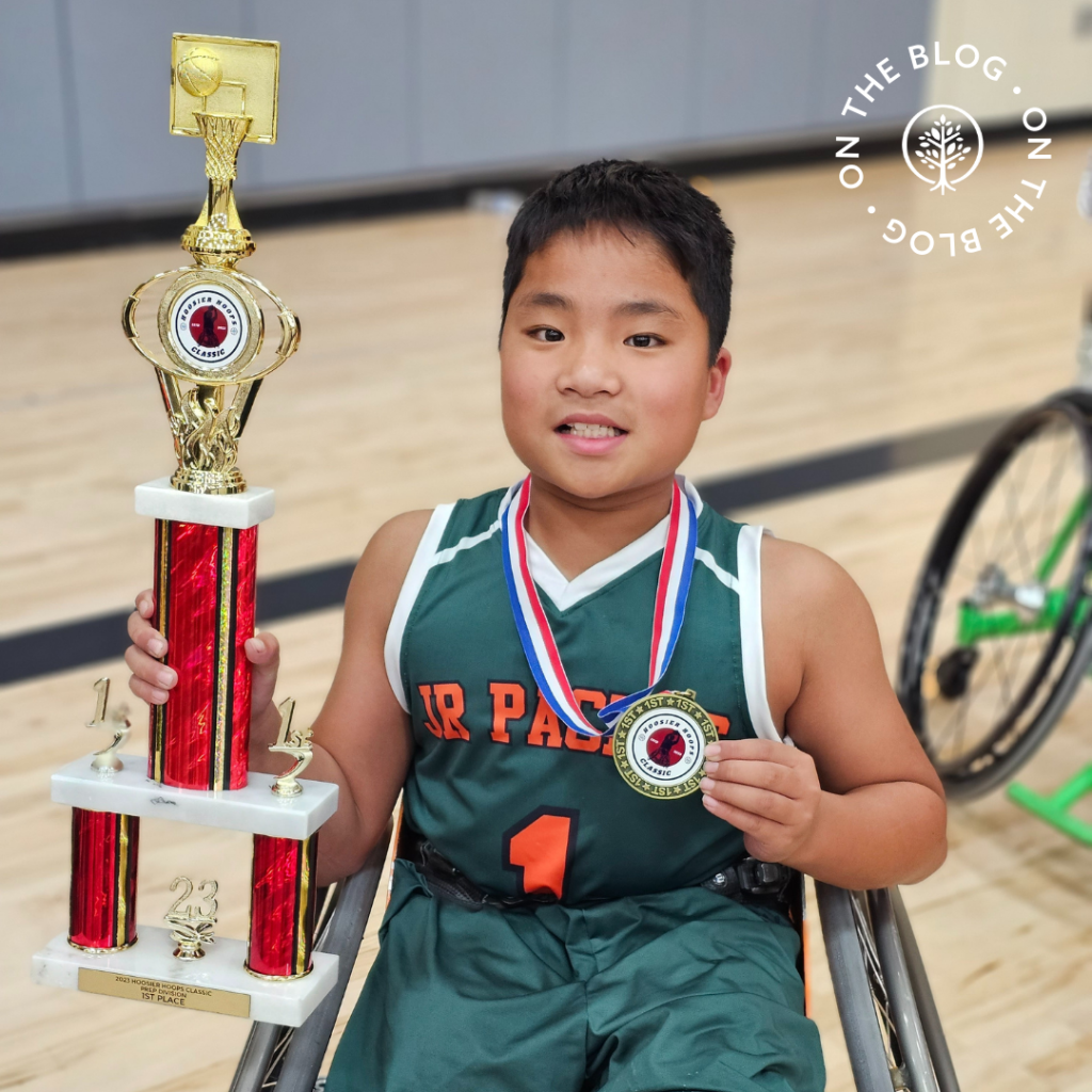 Fuxi Kladder holding a trophy for baskeball