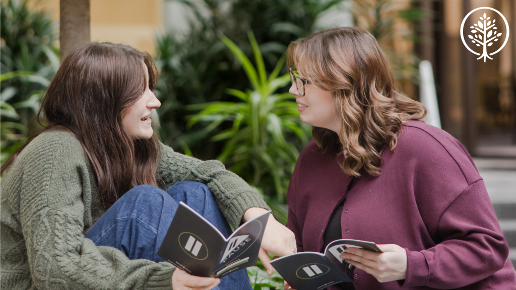 2 women talking with Show Hope's Pause Campaign books