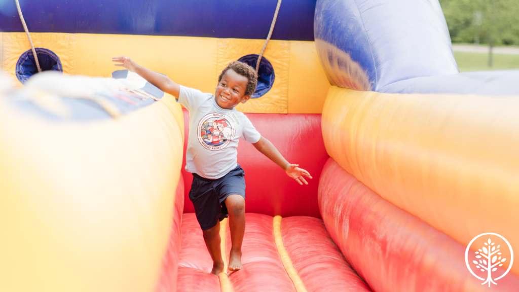 Young boy running on an inflatable